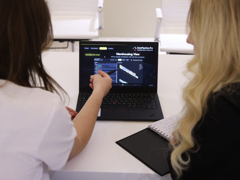 DataPipeline.Pro colleagues reviewing a warehouse analytics solution on a laptop.